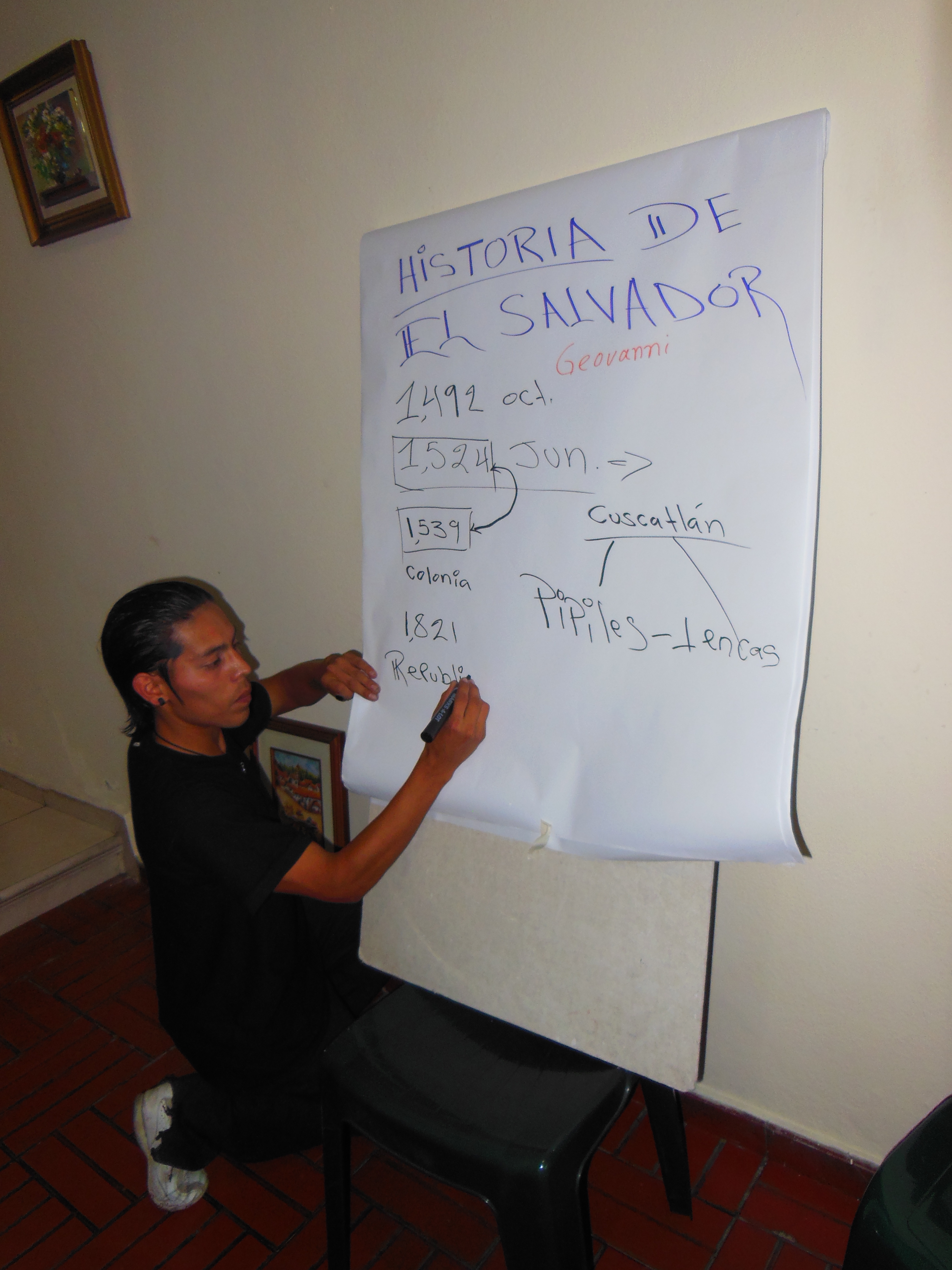 Geovani, a sociology student, gives a presentation on "The People's History of El Salvador" for a delegation. 